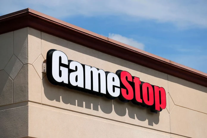 A line chart showing GameStop's stock price surging upwards, with a social media icon in the background.