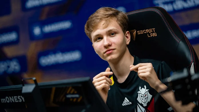 A portrait of m0NESY in his G2 Esports jersey, holding the CS2 10-Year Veteran Coin.